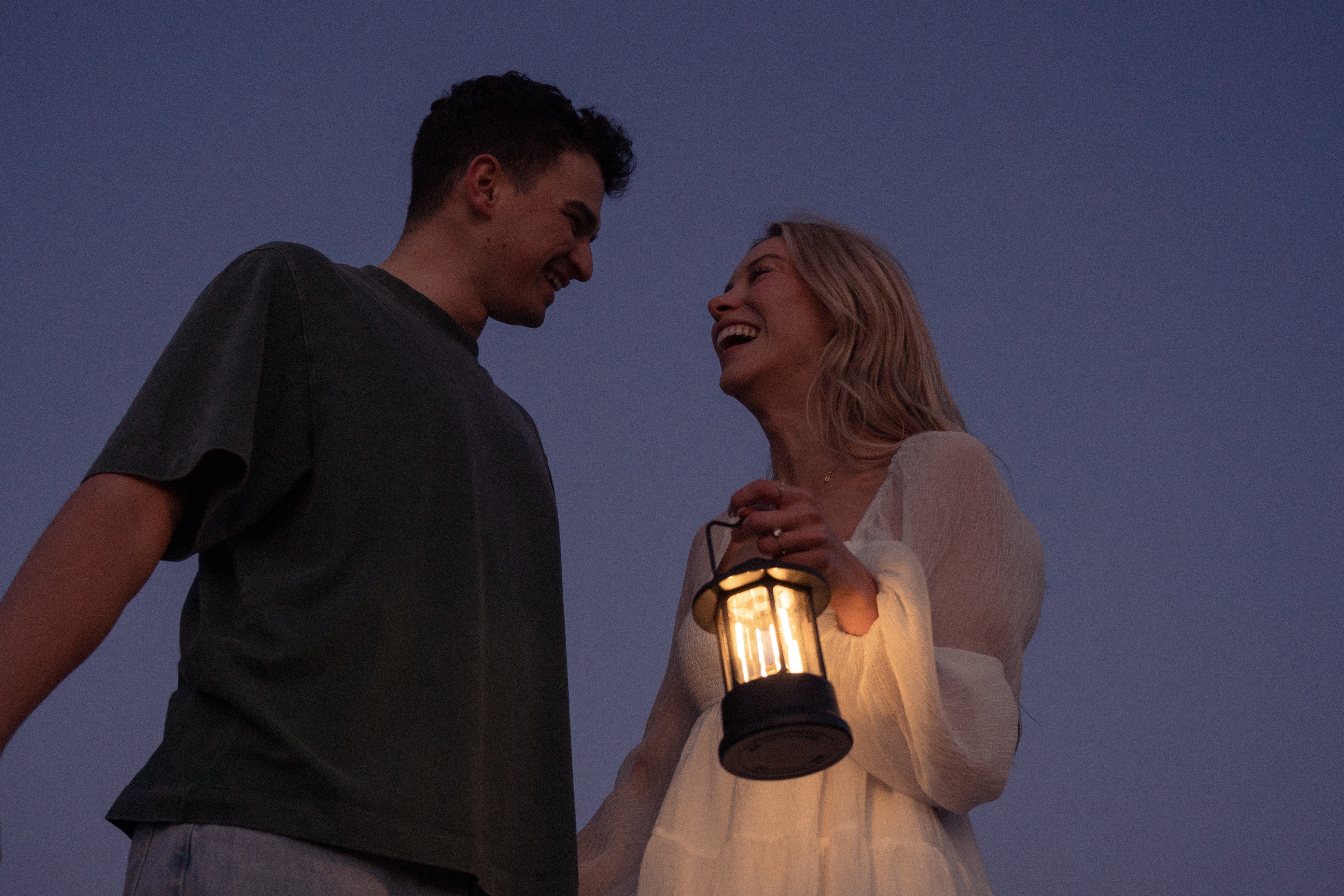 Reuben and Vanessa at dusk holding a lantern