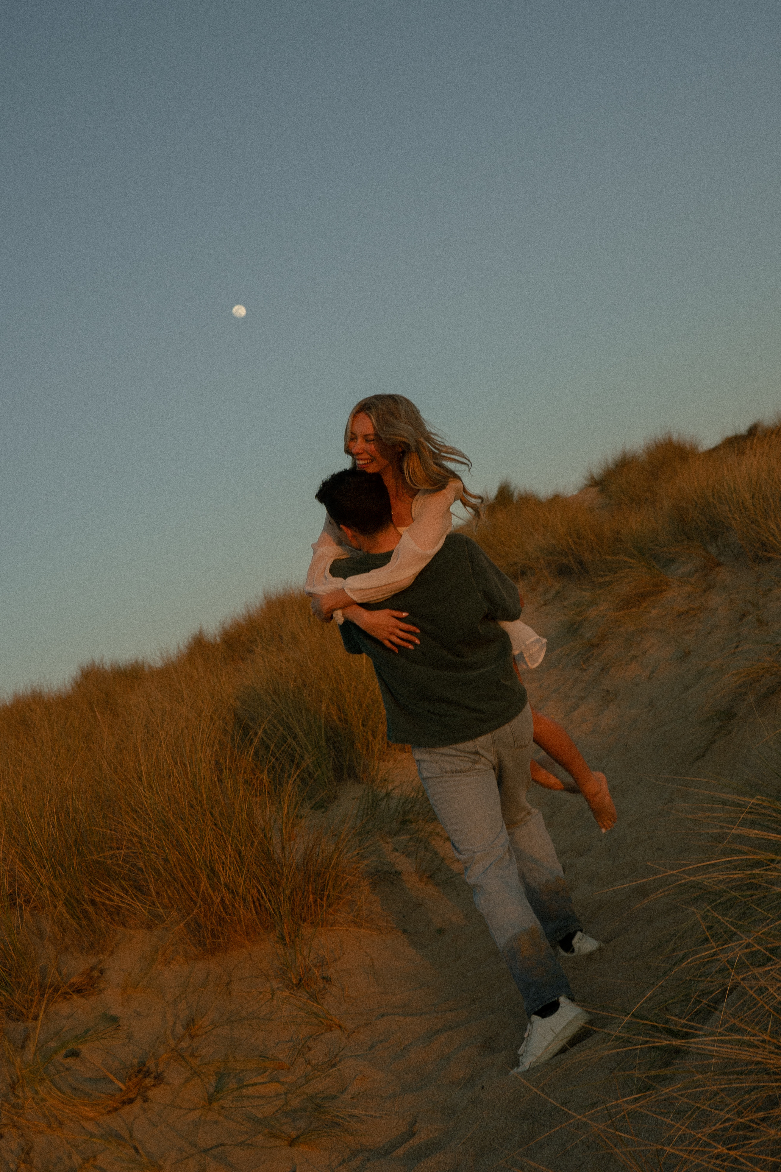 Reuben and Vanessa standing by the shoreline