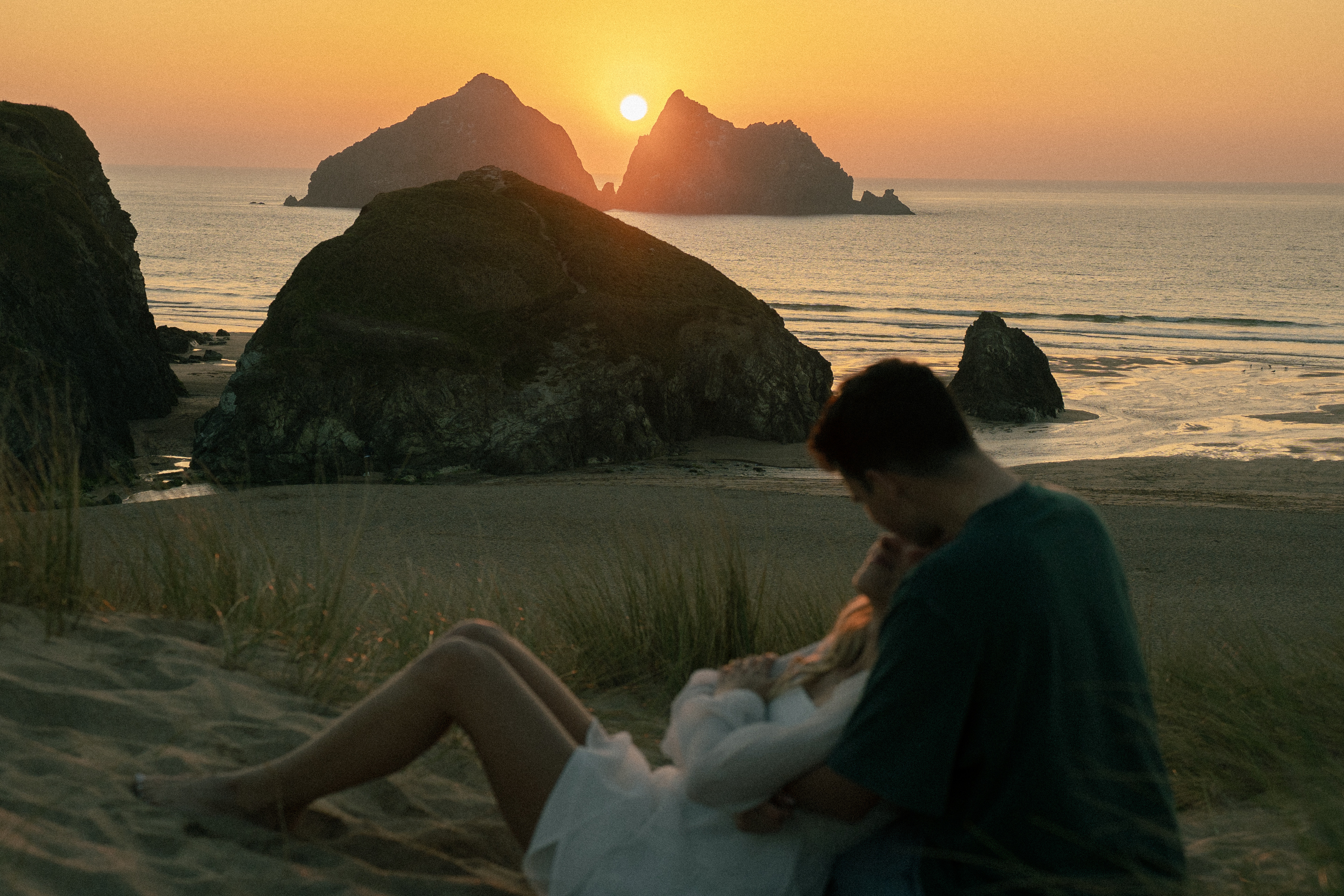 Reuben and Vanessa with a bright sunset behind them