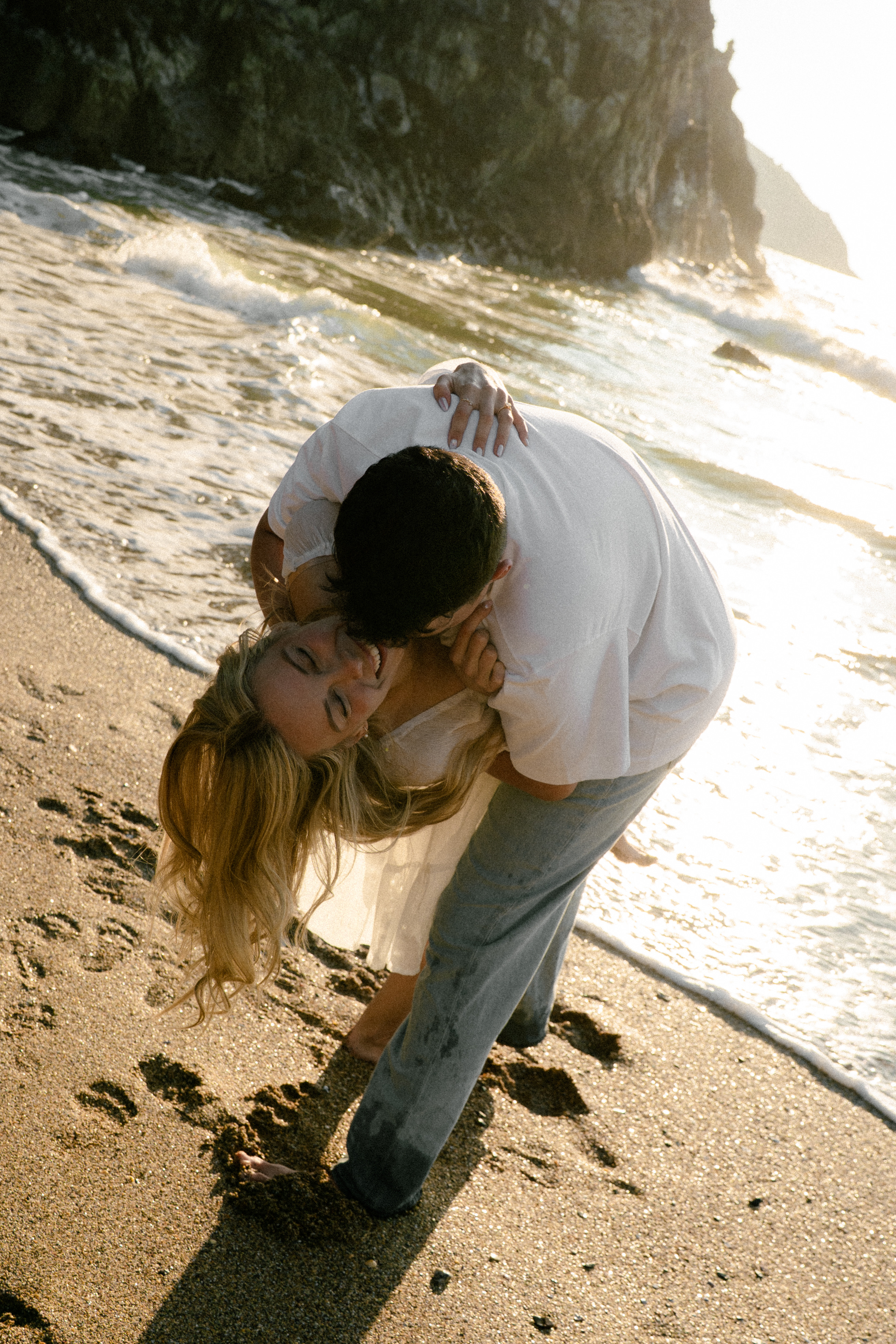 Reuben and Vanessa kissing on the beach